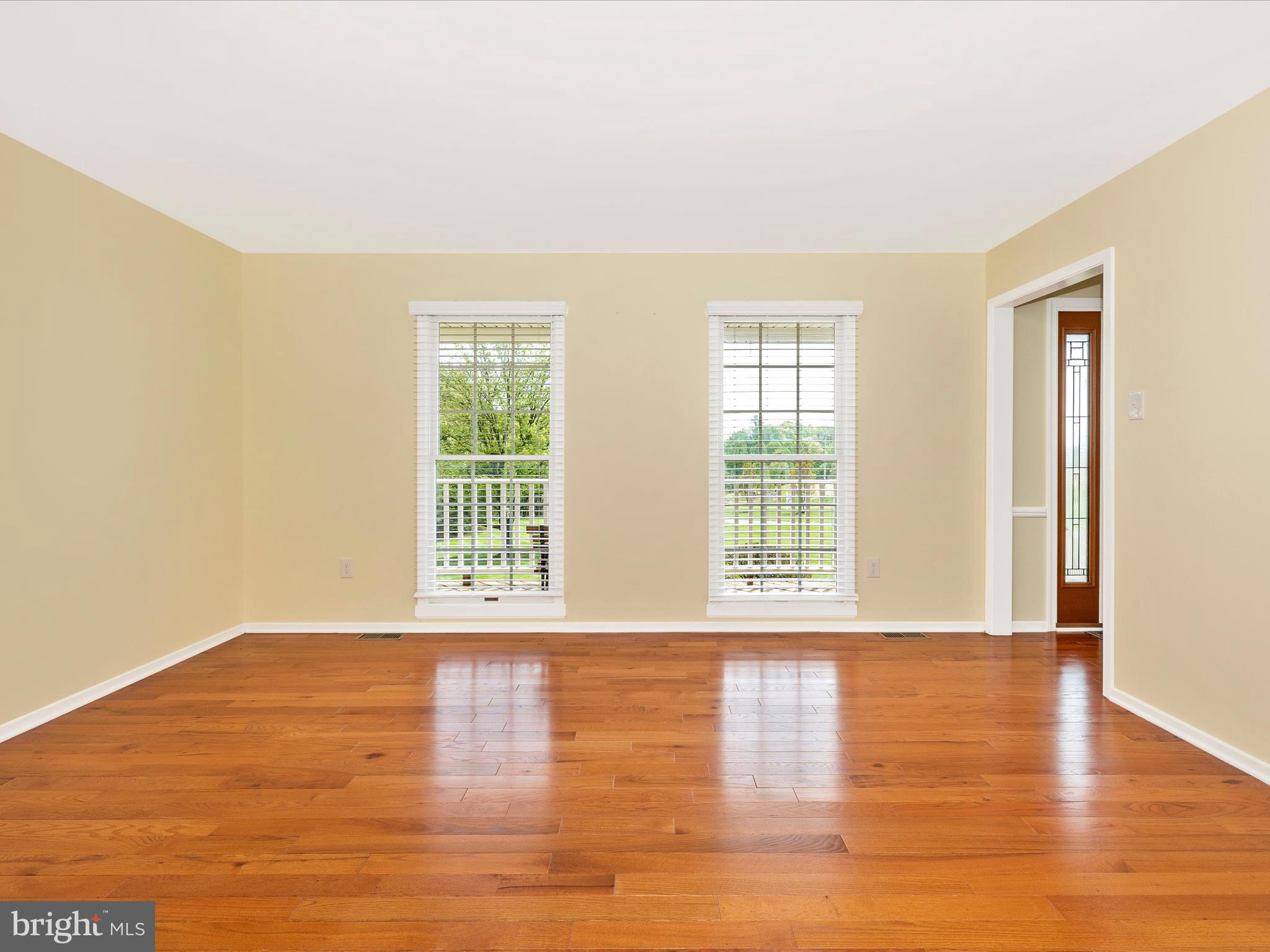 4503 Bartholows Road Mount Airy, MD 21771 - Photo 10 of 65 a view of an empty room with wooden floor and a window