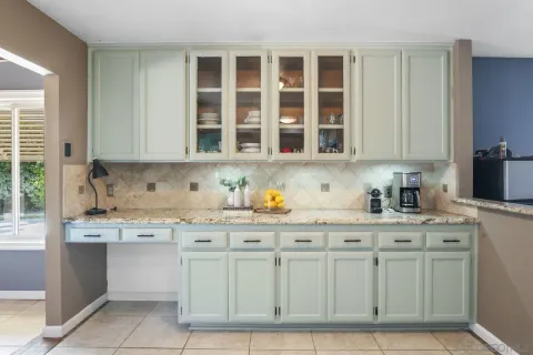 a kitchen with granite countertop cabinets and window