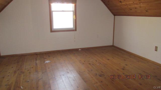 1163 Timber Hill Road Henryville, PA 18332 - Photo 7 of 8 an empty room with wooden floor and windows