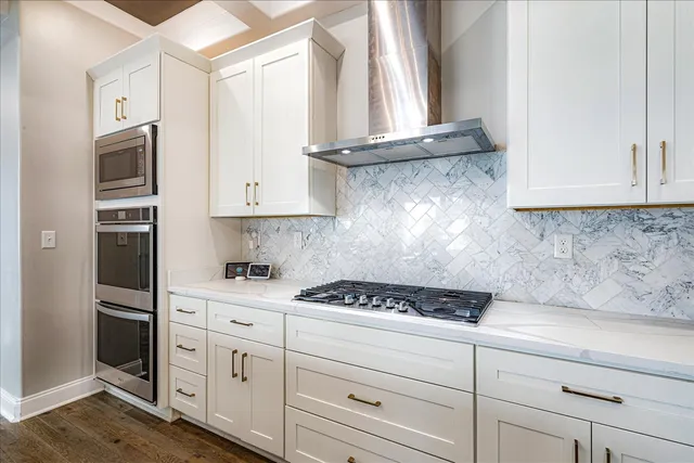 a kitchen with granite countertop white cabinets and white appliances