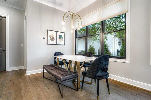 a dining room with furniture and wooden floor