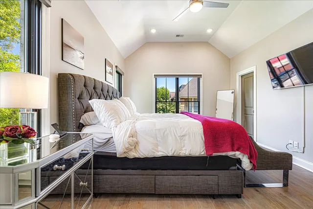 a bed room with a bed and a potted plant