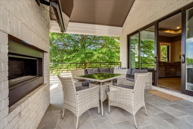 a view of a patio with a table chairs and a backyard