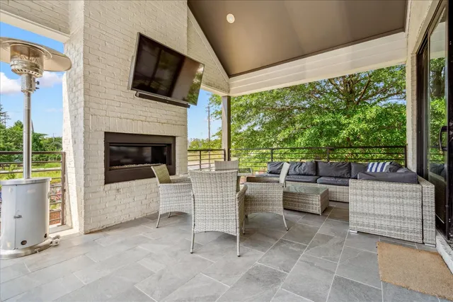 a living room with furniture a flat screen tv and a fireplace