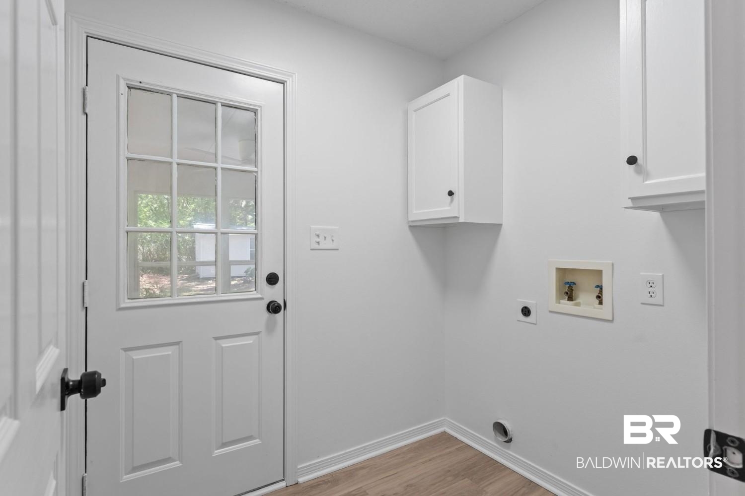 10251 Windmill Road Fairhope, AL 36532 - Photo 39 of 44 Washroom with electric dryer hookup, cabinet space, hookup for a washing machine, and light wood-style flooring