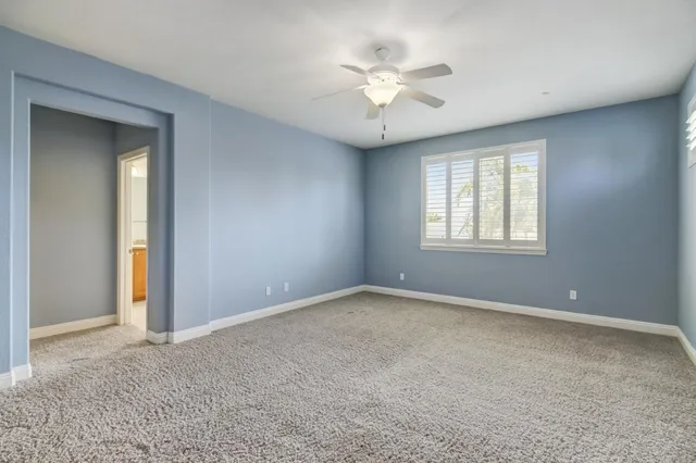 a bathroom with a granite countertop double vanity sink and a mirror