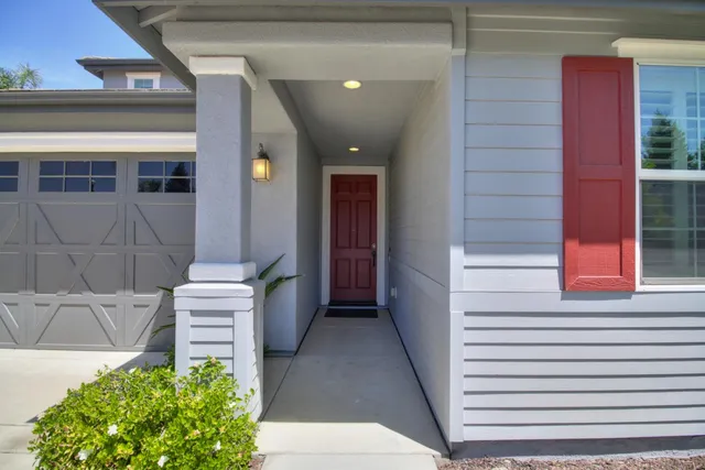 a living room with furniture and a dining table