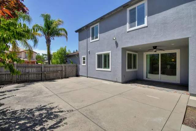 a kitchen with stainless steel appliances a refrigerator a stove a sink a dining table and chairs