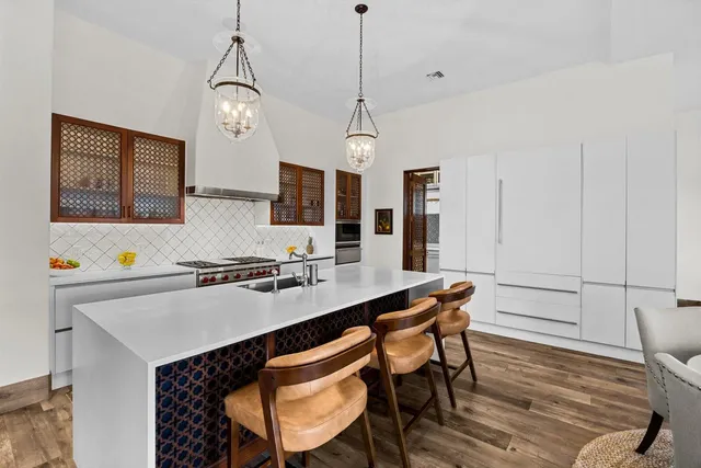 a living room with furniture a rug and a chandelier