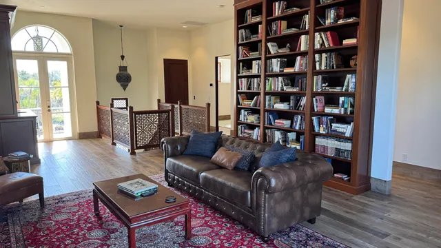 a living room with furniture and a book shelf