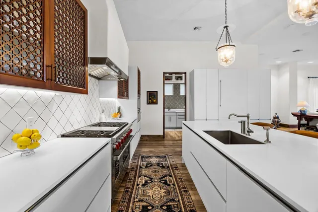a bathroom with a double vanity sink mirror and toilet
