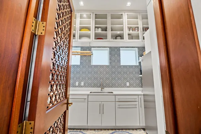 a spacious bathroom with a toilet a sink and mirror