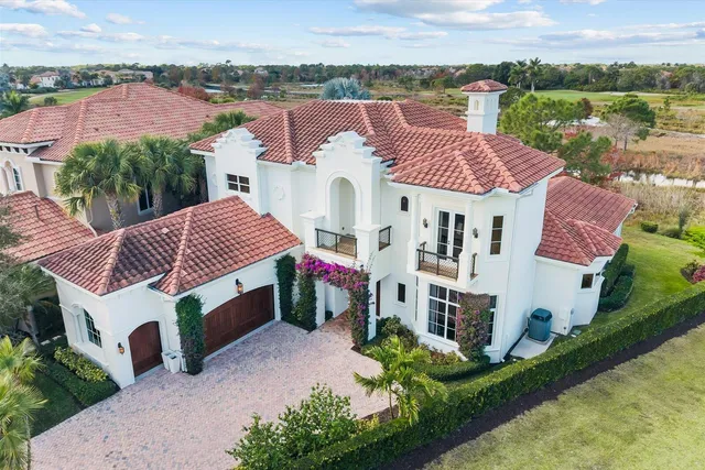 a view of a hallway with paintings on the wall and floor to ceiling window