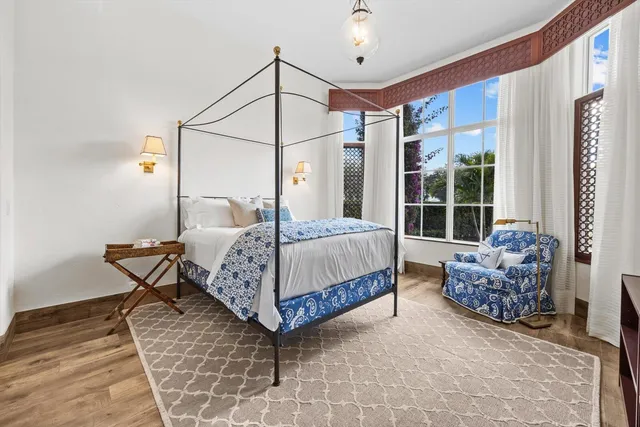 a bedroom with a bed and a chandelier