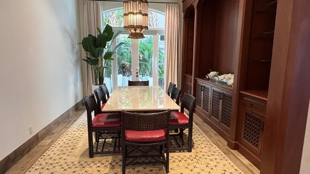 a dining room with furniture a rug and wooden floor