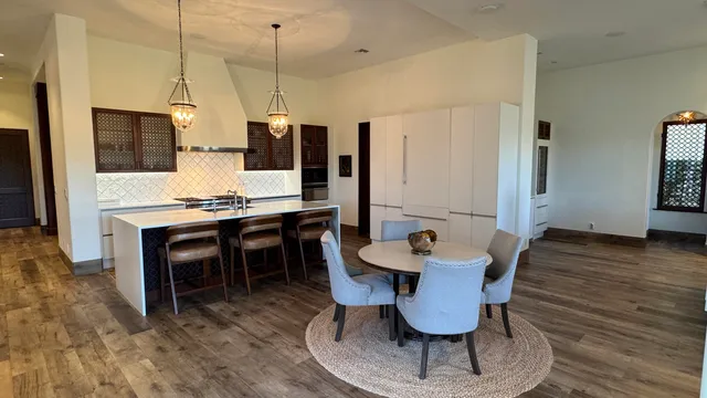 a dining room with furniture and wooden floor