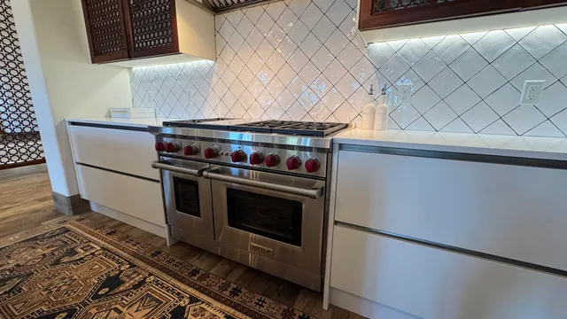 a stove top oven sitting inside of a kitchen