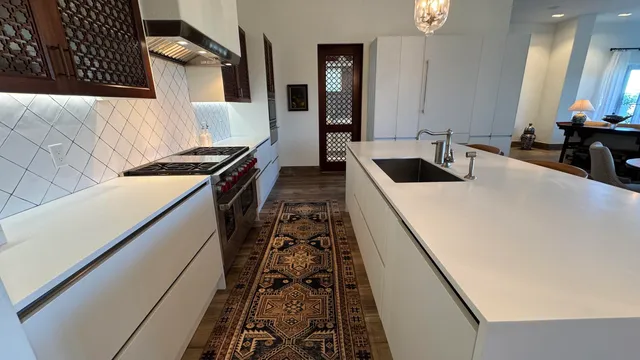 a kitchen with sink stove and refrigerator