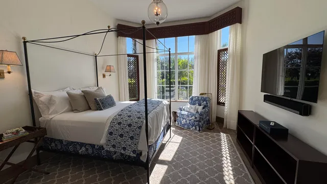 a bed room with a bed and a chandelier