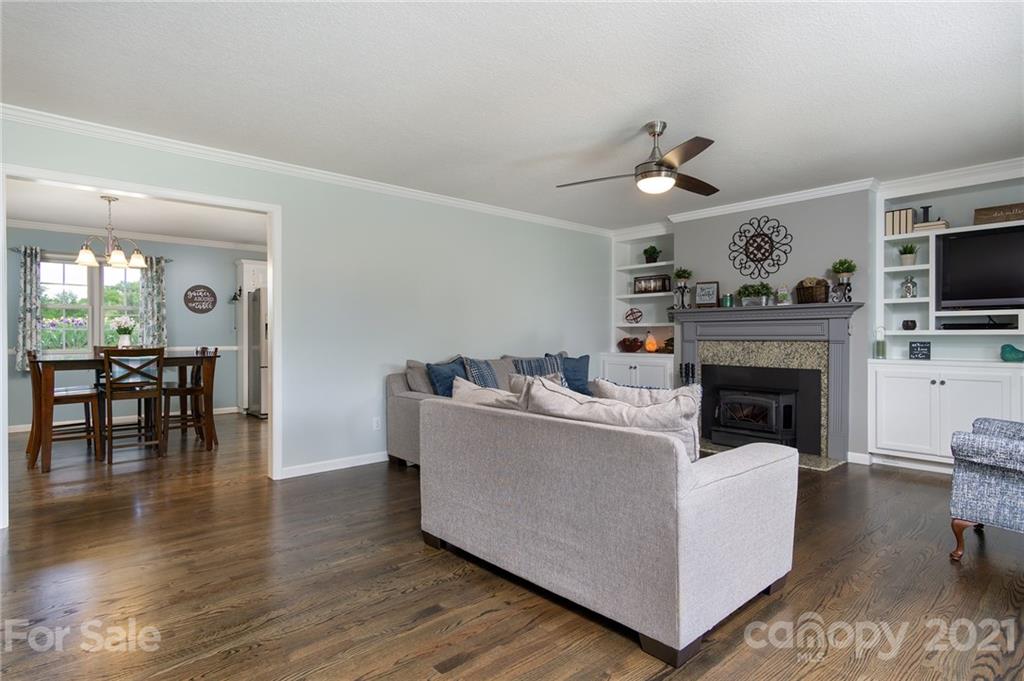 116 Kay Road Flat Rock, NC 28731 - Photo 9 of 36 a living room with furniture a fireplace and a flat screen tv