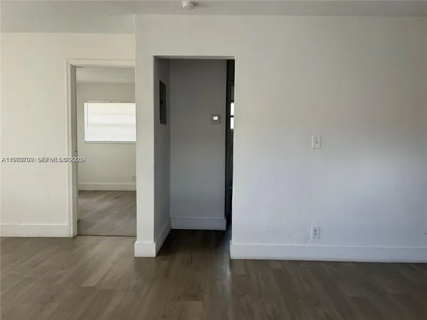 an empty room with wooden floor and closet