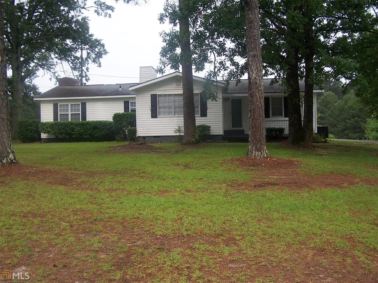 1176 Salem Road LaGrange, GA 30241 - Photo 1 of 1 a view of a yard in front of a house with plants and large tree