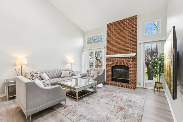 a living room with furniture a window and a fireplace