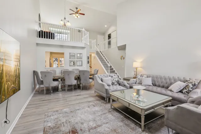 a living room with furniture a rug and a window