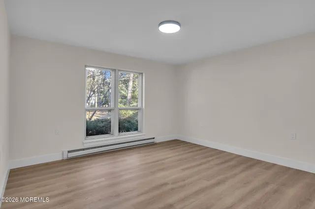 wooden floor in an empty room with a window