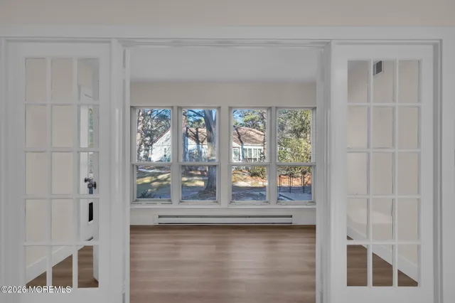 a view of a livingroom with wooden floor and a window