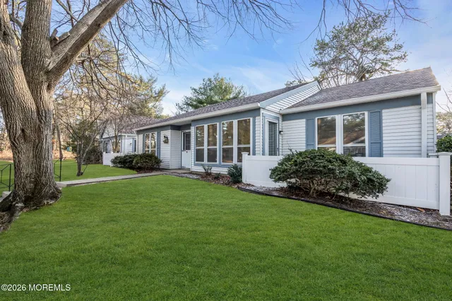 a front view of house with yard and green space