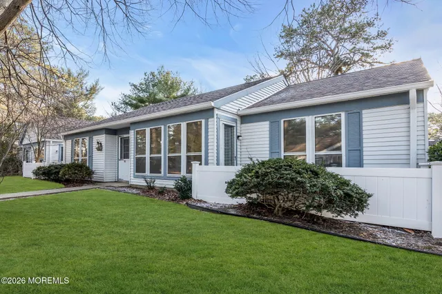 a front view of house with yard and green space