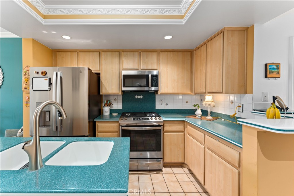 1340 Glenwood Road, Unit 28 Glendale, CA 91201 - Photo 17 of 36 a kitchen with stainless steel appliances granite countertop a stove a sink dishwasher a refrigerator and a microwave