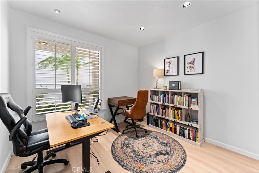 1340 Glenwood Road, Unit 28 Glendale, CA 91201 - Photo 5 of 36 a view of a workspace with furniture and a bookshelf