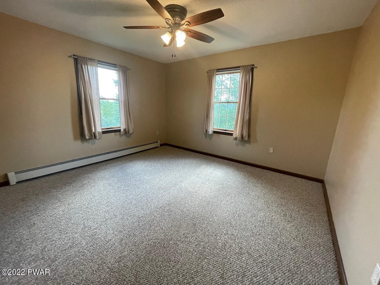 524 Creamton Drive Prompton, PA 18456 - Photo 40 of 57 an empty room with windows and fan