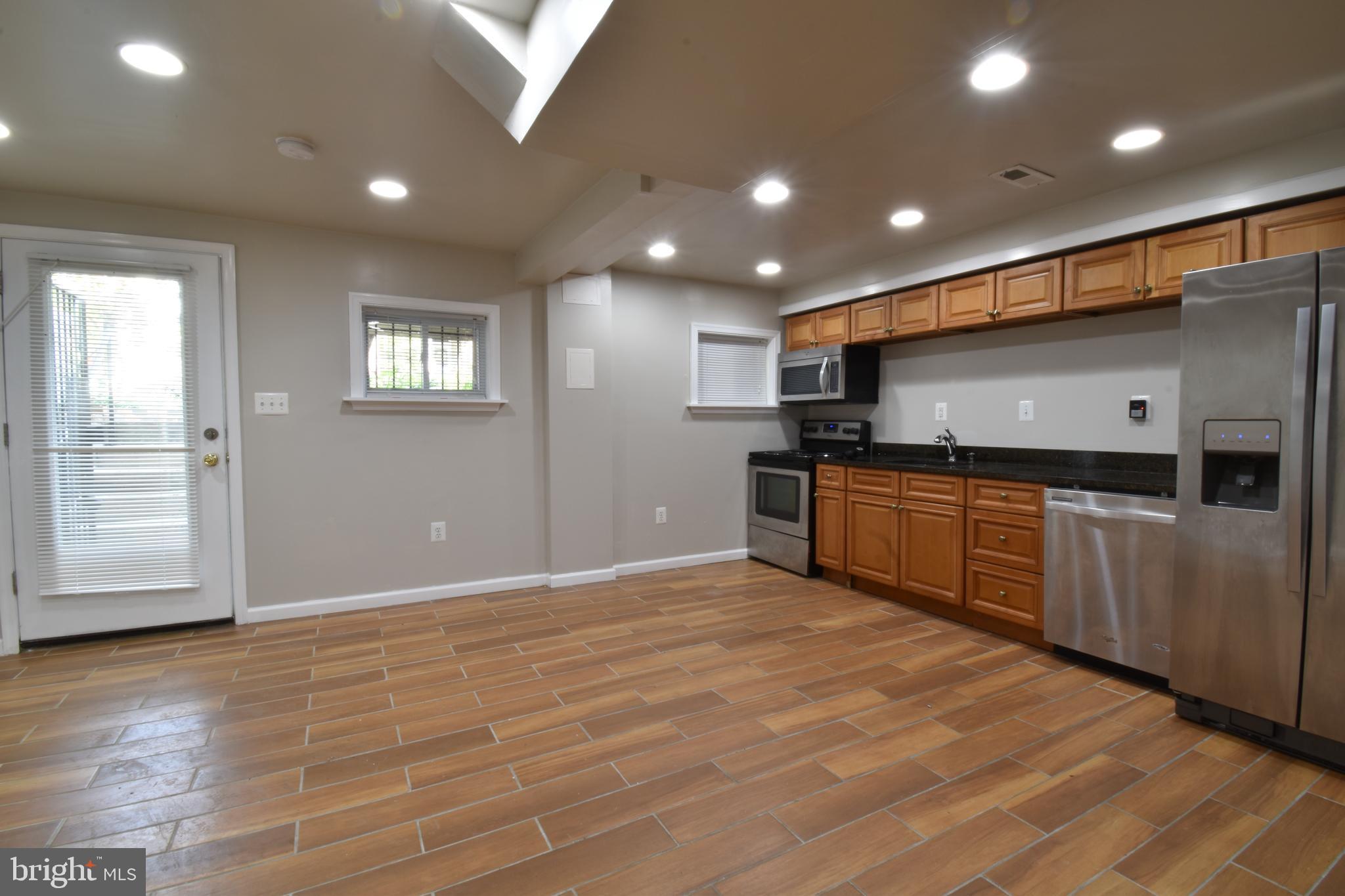 620 Princeton Place Northwest, Unit B Washington, DC 20010 - Photo 4 of 13 a kitchen with stainless steel appliances granite countertop a sink and cabinets