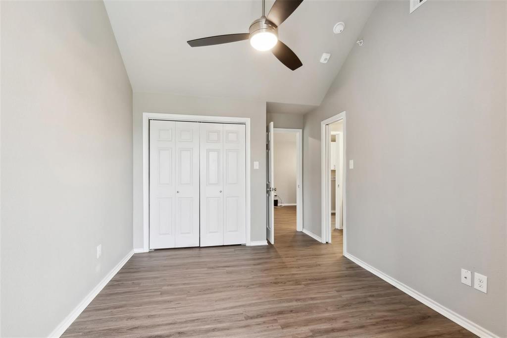 6108 Abrams Road, Unit 530 Dallas, TX 75231 - Photo 11 of 19 an empty room with wooden floor ceiling fan and window