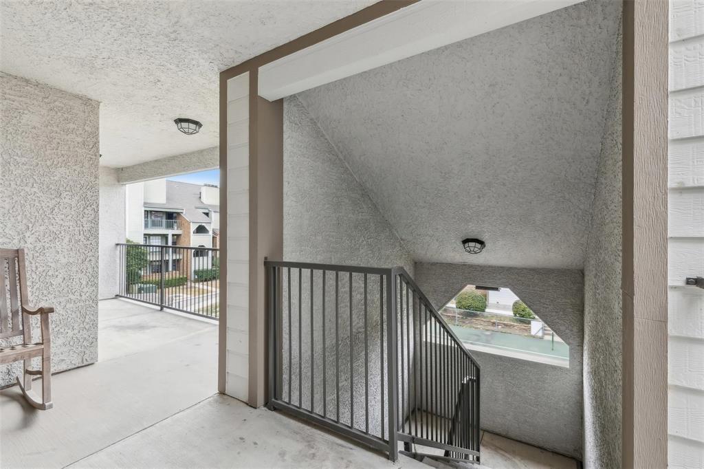 6108 Abrams Road, Unit 530 Dallas, TX 75231 - Photo 14 of 19 a view of a hallway with wooden floor and a bathroom