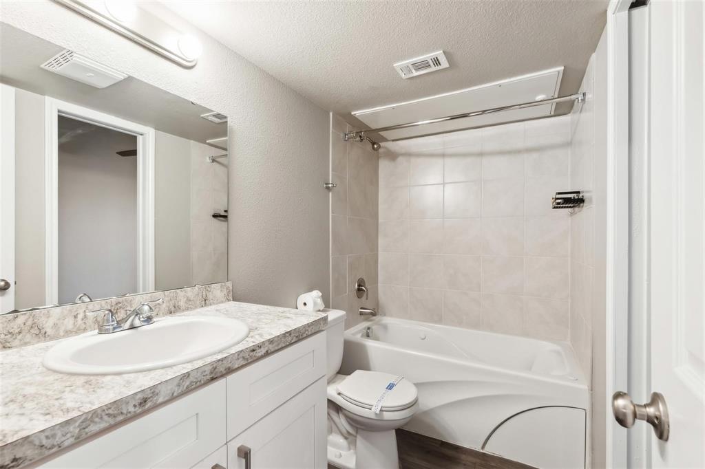 6108 Abrams Road, Unit 530 Dallas, TX 75231 - Photo 6 of 19 a bathroom with a granite countertop sink toilet and shower