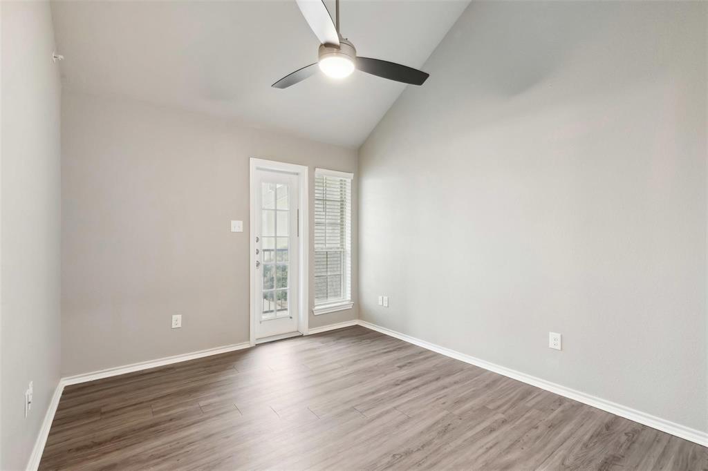 6108 Abrams Road, Unit 530 Dallas, TX 75231 - Photo 8 of 19 an empty room with wooden floor chandelier fan and windows