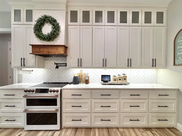 a kitchen with stainless steel appliances a stove and cabinets