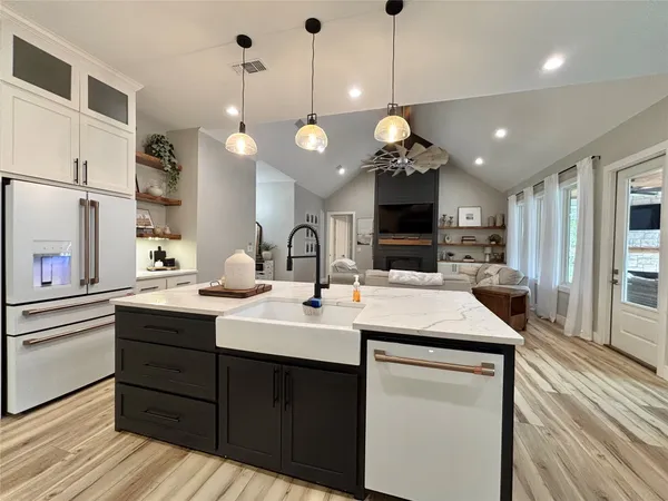 a kitchen with a sink and a stove top oven