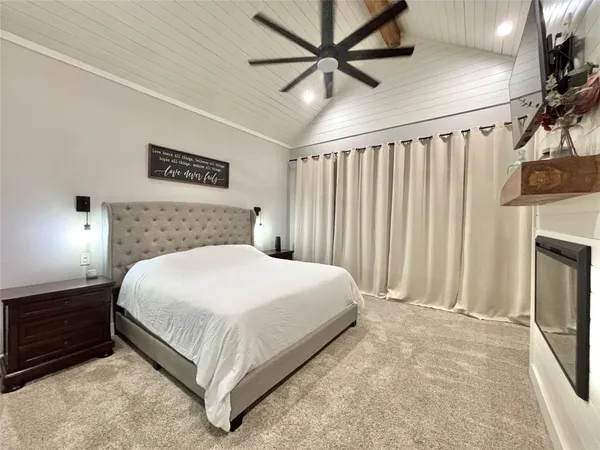 a bedroom with a large bed and a chandelier