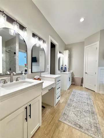 a large bathroom with a double vanity sink and a mirror