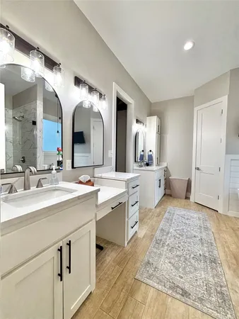 a large bathroom with a double vanity sink and a mirror