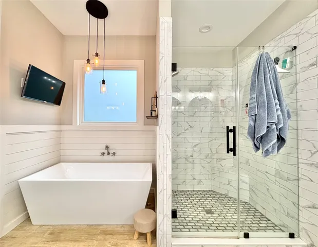 a bathroom with a bathtub and a shower