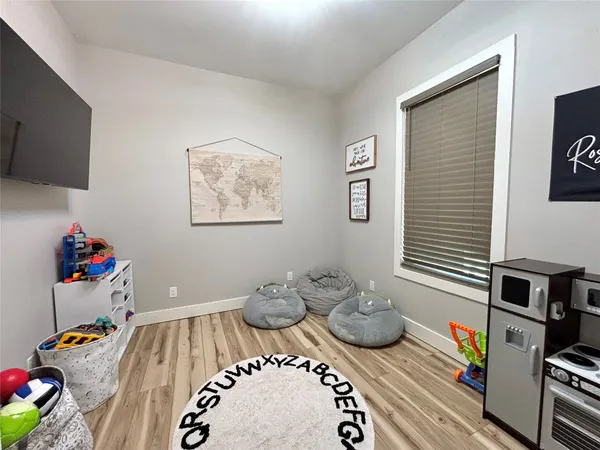 a bedroom with furniture and a wooden floor