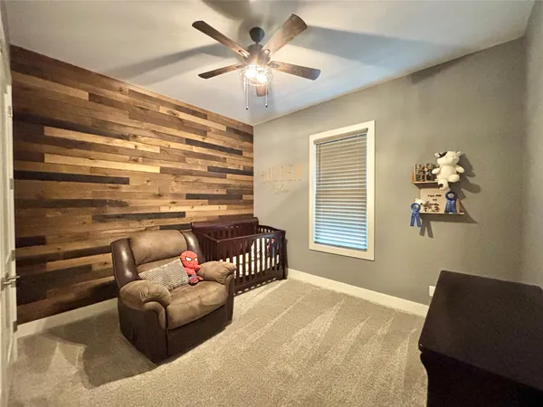 a bedroom with a bed couch and a window