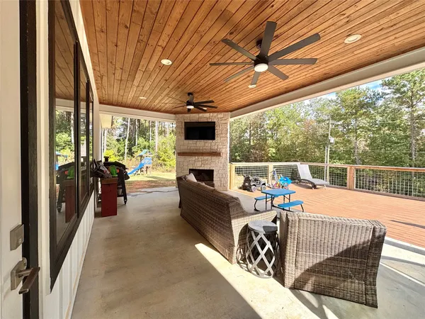 a balcony with furniture and a fireplace