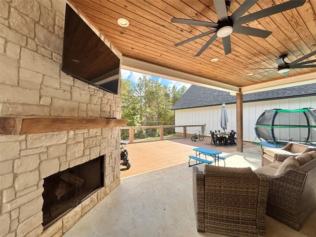 a living room with furniture a fireplace and a table